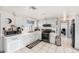 Bright kitchen with white cabinets and sleek appliances at 10737 Scenic Dr, Port Richey, FL 34668