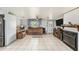Comfortable living room featuring tiled floors, a ceiling fan, and an electric fireplace at 10737 Scenic Dr, Port Richey, FL 34668