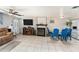 Open-concept living room and dining area featuring tiled floors and an electric fireplace at 10737 Scenic Dr, Port Richey, FL 34668