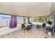 The bright sunroom has a tile floor, plenty of seating and is great for relaxation at 10737 Scenic Dr, Port Richey, FL 34668