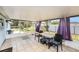 Bright sunroom featuring tile floors, a ceiling, and large windows perfect for enjoying natural light at 10737 Scenic Dr, Port Richey, FL 34668
