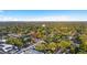 Expansive aerial view showcases neighborhood homes nestled among verdant mature trees under bright blue skies at 110 W Hiawatha St, Tampa, FL 33604