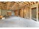 Basement with a concrete floor, block walls, exposed beams, and the framed stairwell ready for completion at 110 W Hiawatha St, Tampa, FL 33604