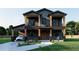 Striking two-story home with a covered car port, wooden pillars, complemented by beautifully landscaped front yard at 110 W Hiawatha St, Tampa, FL 33604
