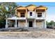 View of new two-story home under construction featuring a foundation, first floor, and a framed second story at 110 W Hiawatha St, Tampa, FL 33604