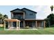 Attractive two-story house featuring a patio with pergola, complemented by a spacious backyard at 110 W Hiawatha St, Tampa, FL 33604
