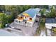 New home construction featuring exterior framing, sheathing and a partial roof in a residential neighborhood at 110 W Hiawatha St, Tampa, FL 33604