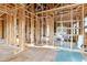 Interior view of the new home construction with wood framing, sheathing and exposed ceiling at 110 W Hiawatha St, Tampa, FL 33604