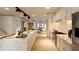 Open-concept kitchen featuring a marble island with seating that opens up to a cozy living room at 110 W Hiawatha St, Tampa, FL 33604
