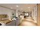 Open-concept living room with a modern gray sofa, a television, and seamless flow into the kitchen at 110 W Hiawatha St, Tampa, FL 33604