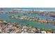 Expansive aerial view of waterfront community with private docks and stunning coastal scenery, showcasing waterfront living at 11340 5Th E St, Treasure Island, FL 33706