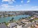 Aerial view of a waterfront community with homes, canals, and a view of the beach in the distance at 11340 5Th E St, Treasure Island, FL 33706