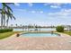 Lush backyard with brick patio, swimming pool, grassy lawn, and waterfront views for relaxation and recreation at 11340 5Th E St, Treasure Island, FL 33706