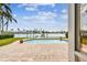 Backyard with brick patio, swimming pool, lawn and waterfront views, perfect for outdoor living at 11340 5Th E St, Treasure Island, FL 33706
