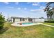 Expansive backyard with a pool and lush green lawn at 11340 5Th E St, Treasure Island, FL 33706