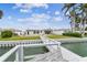 Backyard from dockside offering a grassy lawn, tranquil waterfront views, and a glimpse of the home at 11340 5Th E St, Treasure Island, FL 33706
