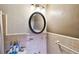 Close-up of pink tiled bathroom with mirror, toilet, and towel rack at 11340 5Th E St, Treasure Island, FL 33706