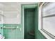 Bright, quaint vintage-style bathroom featuring green tile and classic fixtures at 11340 5Th E St, Treasure Island, FL 33706