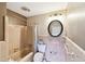 A pink tiled bathroom with a toilet, bathtub, shower, and mirror at 11340 5Th E St, Treasure Island, FL 33706