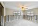 Bright room with a ceiling fan and natural light, showcasing exposed concrete block at 11340 5Th E St, Treasure Island, FL 33706