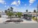 Charming single-story home featuring a spacious driveway with ample parking, mature palm trees, and lush landscaping at 11340 5Th E St, Treasure Island, FL 33706