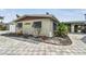 Exterior view of the house showing the brick paved driveway and landscaping at 11340 5Th E St, Treasure Island, FL 33706