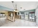 Open-concept living space with tile flooring, featuring natural light and an open layout connecting to kitchen at 11340 5Th E St, Treasure Island, FL 33706