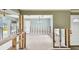 Open living area with tile floors, featuring windows, light fixtures, and an open layout ready for renovation at 11340 5Th E St, Treasure Island, FL 33706