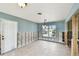 Living room needing renovation, featuring a bright window and neutral tile flooring at 11340 5Th E St, Treasure Island, FL 33706