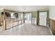 Open living area with tile flooring, connecting to the kitchen, ready for complete renovation and customization at 11340 5Th E St, Treasure Island, FL 33706