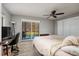 Bedroom featuring a ceiling fan, light gray paint, and natural light from the sliding glass doors at 11708 Raintree Village Blvd # A, Temple Terrace, FL 33617