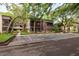 Exterior of a two-story condo building featuring a screened in porch and reserved parking at 11708 Raintree Village Blvd # A, Temple Terrace, FL 33617