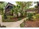 The exterior of a condo building with mature landscaping and a screened-in porch at 11708 Raintree Village Blvd # A, Temple Terrace, FL 33617