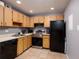 Compact kitchen with neutral cabinets, stainless steel appliances, and gray walls at 11708 Raintree Village Blvd # A, Temple Terrace, FL 33617
