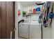 Laundry room featuring a washer, a dryer and wire racks for storage at 11708 Raintree Village Blvd # A, Temple Terrace, FL 33617
