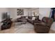 The living room is decorated with a gray sofa, recliner, and a TV at 11708 Raintree Village Blvd # A, Temple Terrace, FL 33617