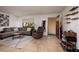 The interior features a gray sofa, recliner, and a brown tile floor at 11708 Raintree Village Blvd # A, Temple Terrace, FL 33617