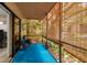 Patio with a blue floor and roll up shades, surrounded by lush landscaping at 11708 Raintree Village Blvd # A, Temple Terrace, FL 33617