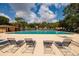 Community pool featuring several lounge chairs around the area at 11708 Raintree Village Blvd # A, Temple Terrace, FL 33617