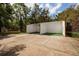 Outdoor racquetball court surrounded by a chain-link fence and shaded by mature trees in a lush community at 11708 Raintree Village Blvd # A, Temple Terrace, FL 33617