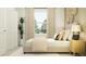 Relaxing bedroom with stylish decor, a neutral color palette, and a large window at 11900 Brae Way, Dade City, FL 33525