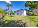 Spacious backyard with lush grass and beautiful landscaping at 13250 Ridge Rd # 4B3, Largo, FL 33778