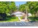Community center entrance surrounded by mature trees and landscaping at 13250 Ridge Rd # 4B3, Largo, FL 33778