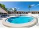 Sparkling community pool surrounded by lush landscaping and lounge chairs at 13250 Ridge Rd # 4B3, Largo, FL 33778