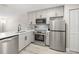 Updated kitchen features stainless steel appliances, gray cabinetry and granite countertops at 13250 Ridge Rd # 4B3, Largo, FL 33778