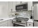 Modern kitchen showcasing stainless steel appliances, stylish backsplash, and bright countertops at 13250 Ridge Rd # 4B3, Largo, FL 33778
