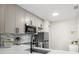 Updated kitchen with stainless steel appliances and stylish backsplash at 13250 Ridge Rd # 4B3, Largo, FL 33778