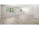 Bright, spacious living room features updated flooring and two large windows at 13250 Ridge Rd # 4B3, Largo, FL 33778