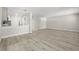 Open-concept living area with updated flooring leads to the kitchen and dining area at 13250 Ridge Rd # 4B3, Largo, FL 33778