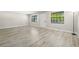 Bright, spacious living room features updated flooring and two large windows at 13250 Ridge Rd # 4B3, Largo, FL 33778
